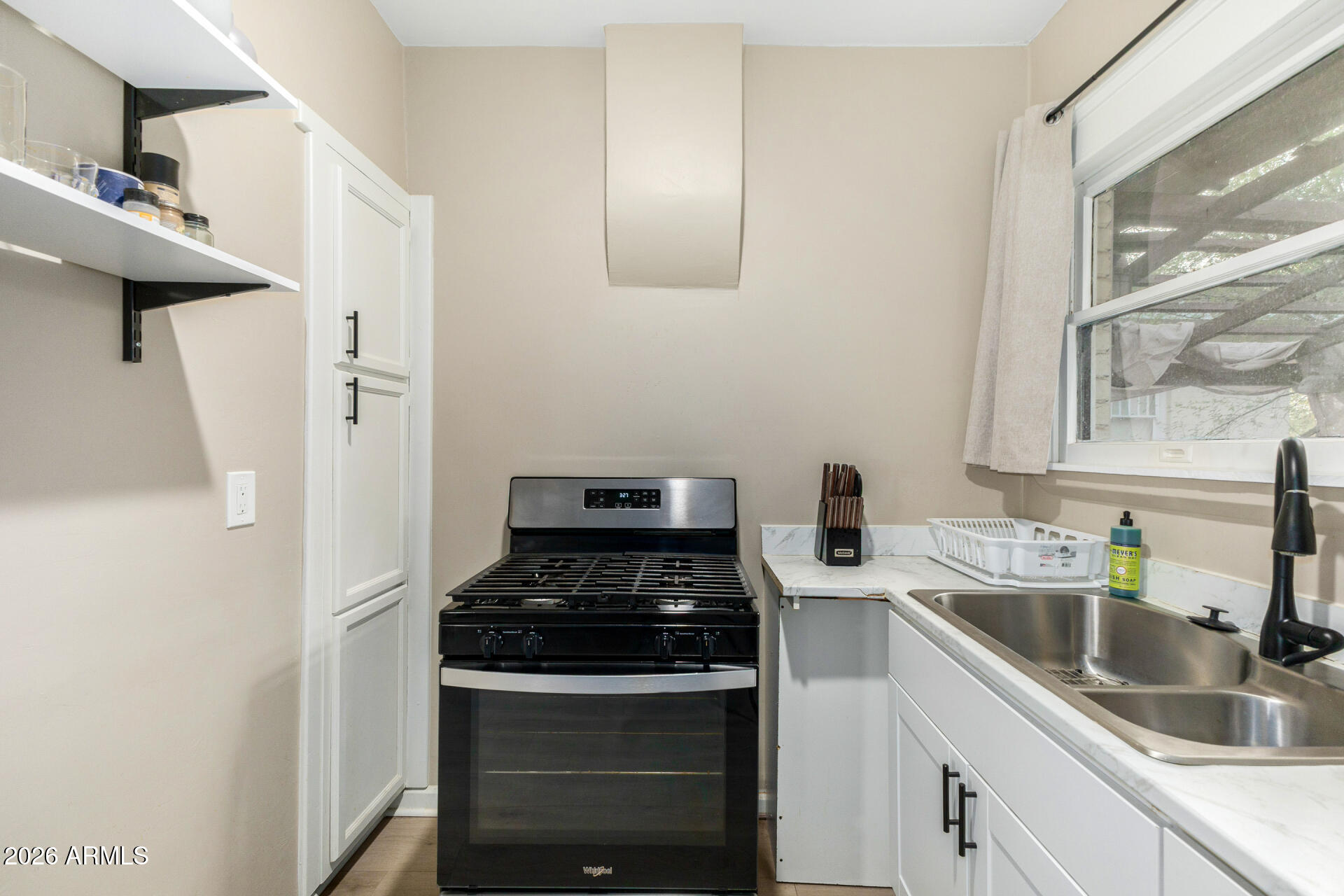 1317 West Monroe Street Phoenix, AZ 85007 - Photo 51 of 86 a kitchen with stainless steel appliances granite countertop a sink stove and refrigerator