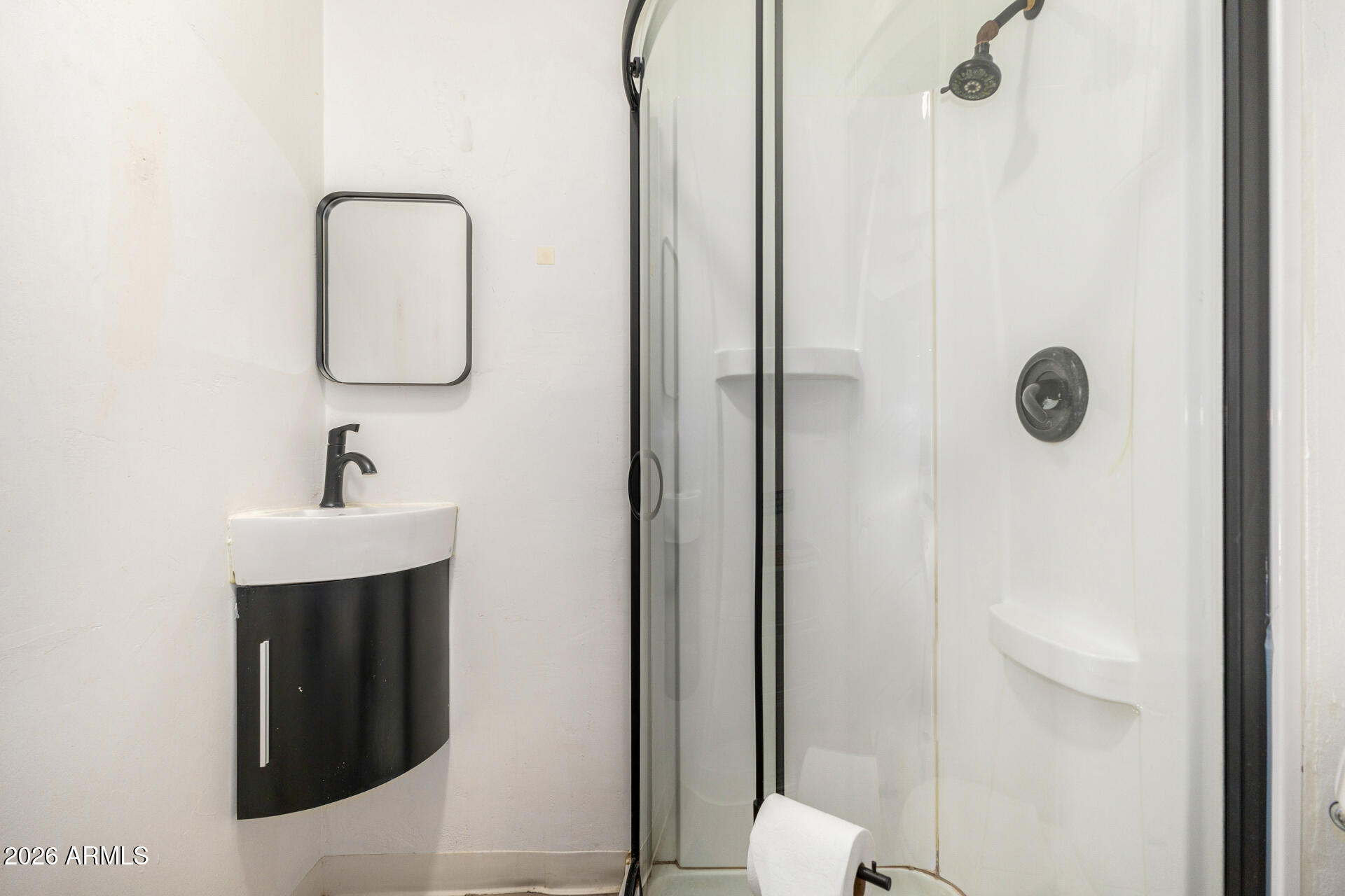 1317 West Monroe Street Phoenix, AZ 85007 - Photo 55 of 86 a bathroom with a sink a mirror a vanity and shower