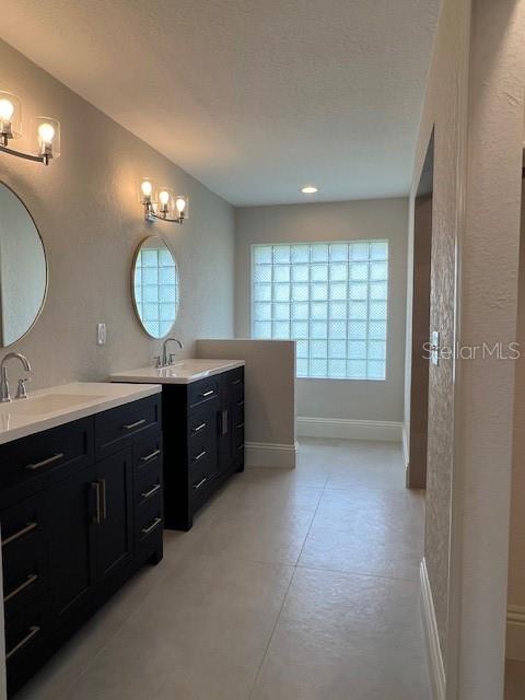 2800 Conway Gardens Road Orlando, FL 32806 - Photo 15 of 23 a spacious bathroom with a vanity a sink a mirror a vanity and a window