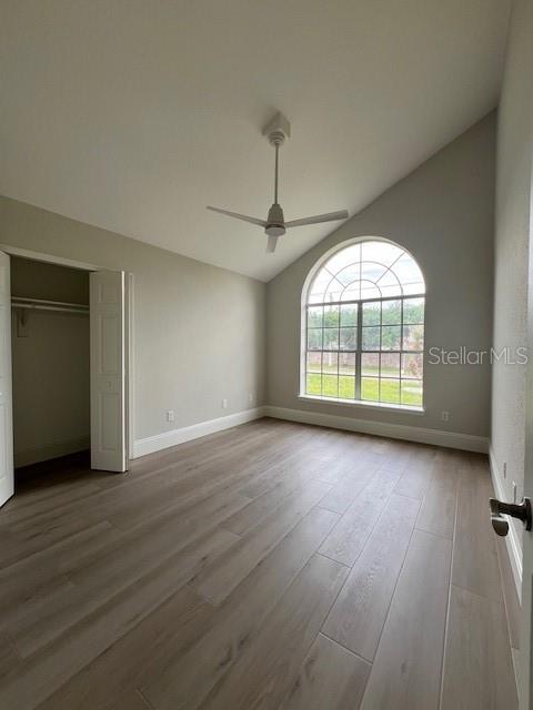2800 Conway Gardens Road Orlando, FL 32806 - Photo 16 of 23 an empty room with wooden floor chandelier and windows