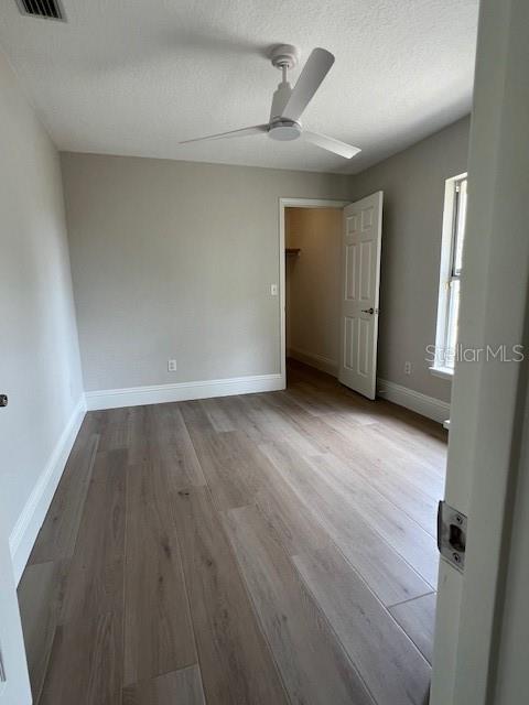 2800 Conway Gardens Road Orlando, FL 32806 - Photo 17 of 23 an empty room with wooden floor and windows