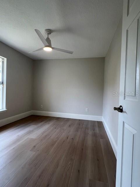 2800 Conway Gardens Road Orlando, FL 32806 - Photo 19 of 23 an empty room with wooden floor and windows