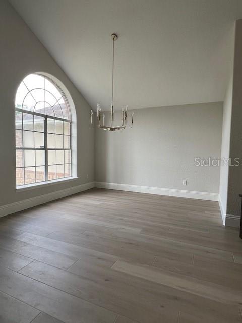 2800 Conway Gardens Road Orlando, FL 32806 - Photo 3 of 23 an empty room with wooden floor cabinet and windows