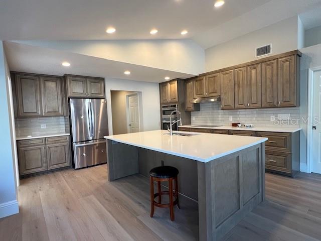 2800 Conway Gardens Road Orlando, FL 32806 - Photo 6 of 23 a kitchen with stainless steel appliances granite countertop a sink stove and refrigerator