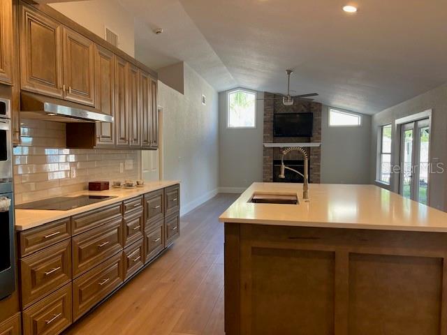 2800 Conway Gardens Road Orlando, FL 32806 - Photo 7 of 23 a kitchen with kitchen island granite countertop a sink dishwasher stove and cabinets
