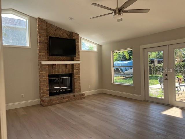 2800 Conway Gardens Road Orlando, FL 32806 - Photo 8 of 23 an empty room with windows fireplace and wooden floor