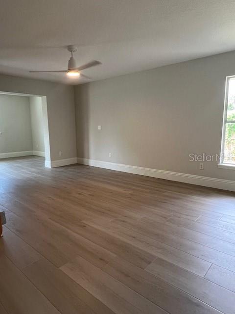 2800 Conway Gardens Road Orlando, FL 32806 - Photo 10 of 23 an empty room with wooden floor and windows