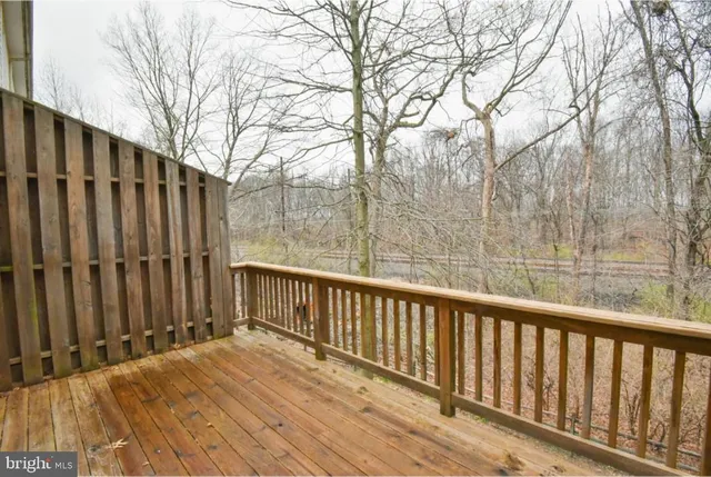 a view of wooden balcony with wooden fence and floor