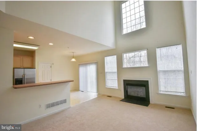 a view of a livingroom with a fireplace and window