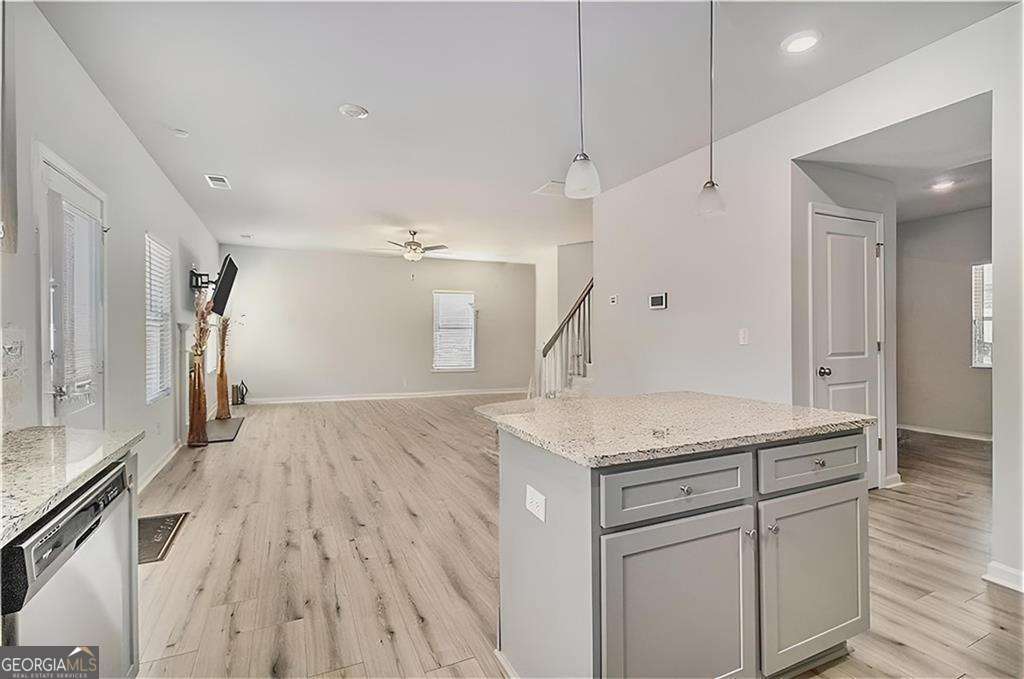1101 Longleaf Trace Monroe, GA 30656 - Photo 14 of 36 a kitchen with a sink dishwasher a refrigerator and a counter space
