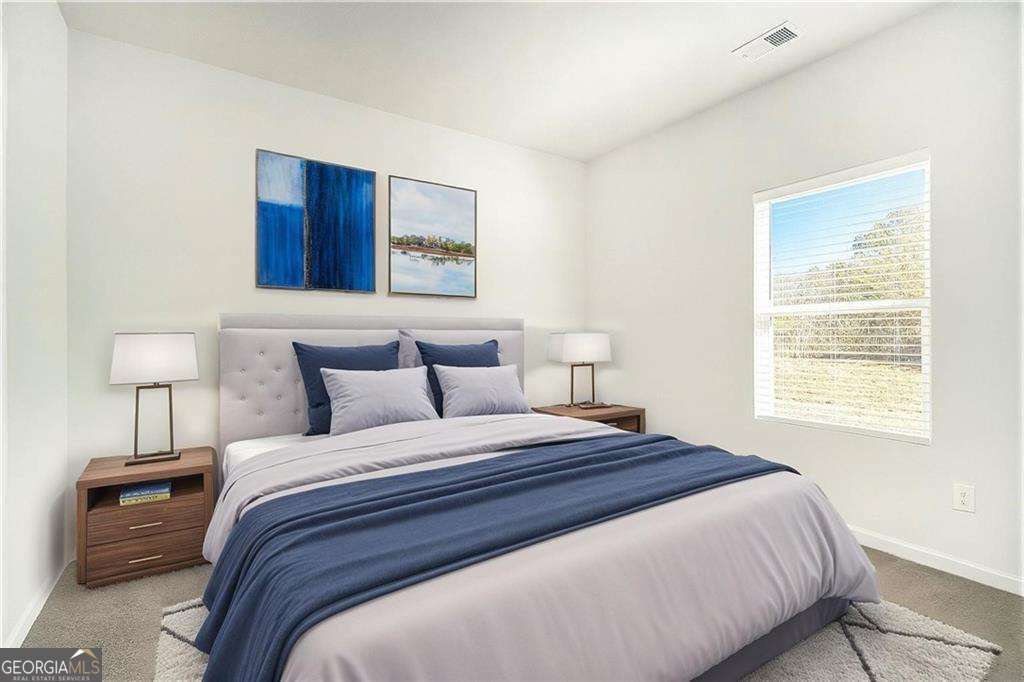 1101 Longleaf Trace Monroe, GA 30656 - Photo 17 of 36 a bedroom with a bed and a night stand