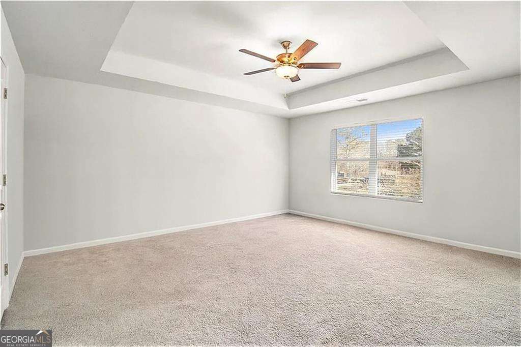 1101 Longleaf Trace Monroe, GA 30656 - Photo 23 of 36 an empty room with windows and fan