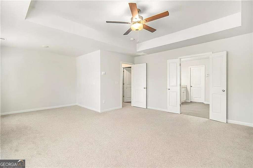 1101 Longleaf Trace Monroe, GA 30656 - Photo 24 of 36 an empty room with closet and a ceiling fan
