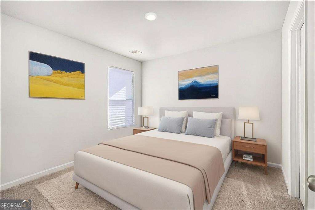 1101 Longleaf Trace Monroe, GA 30656 - Photo 26 of 36 a bedroom with a bed and painting on the wall