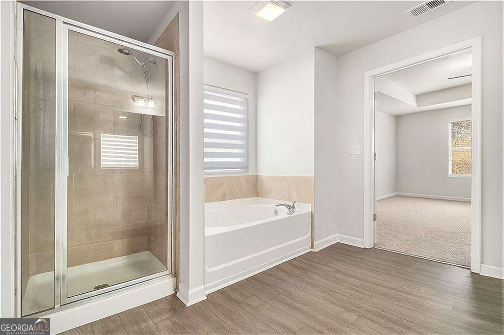 1101 Longleaf Trace Monroe, GA 30656 - Photo 27 of 36 a bathroom with a bathtub and a shower