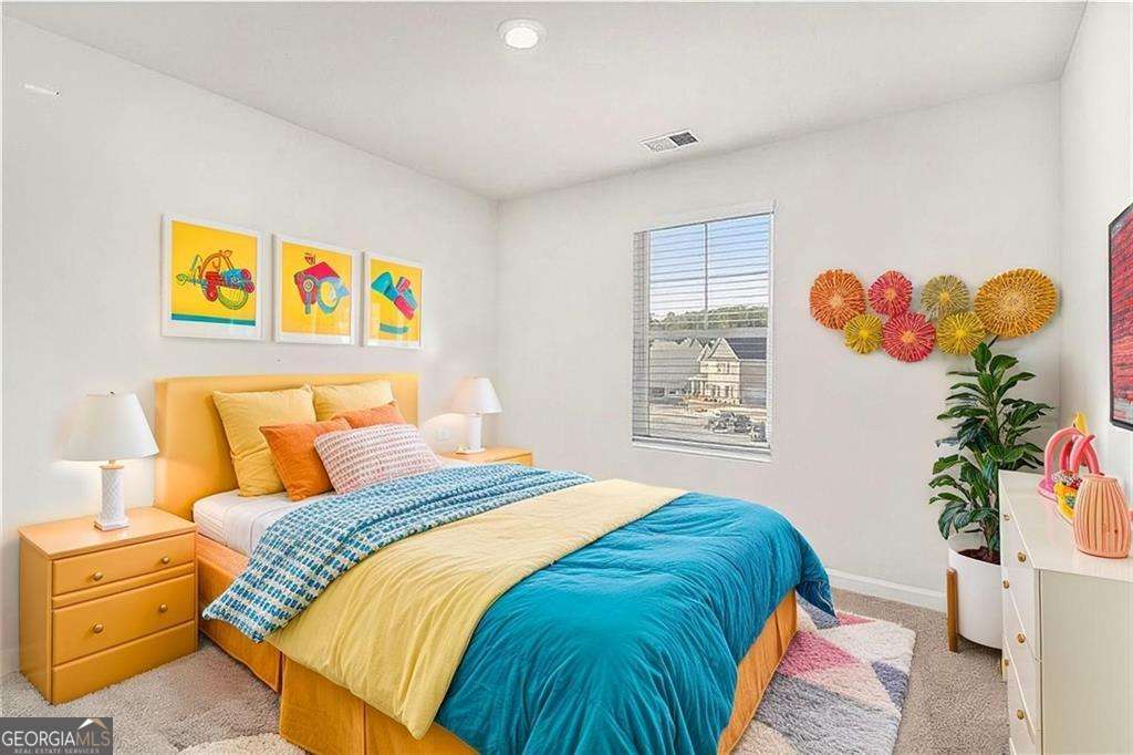 1101 Longleaf Trace Monroe, GA 30656 - Photo 31 of 36 a bedroom with a bed and a painting on the wall