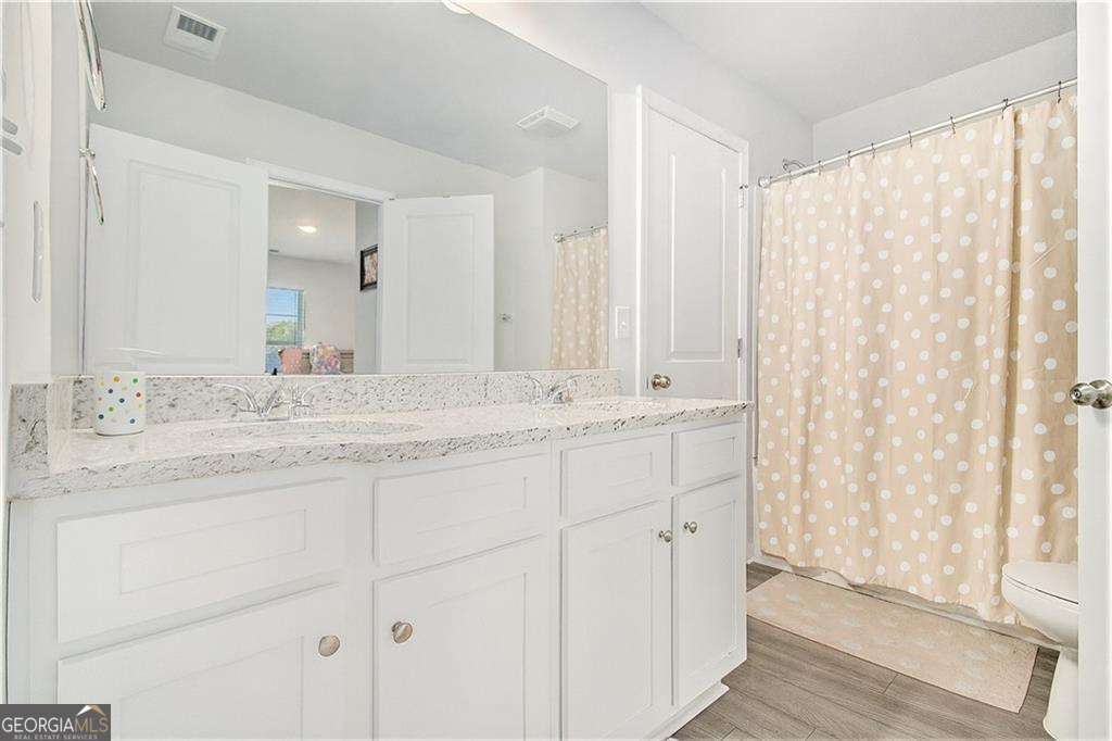 1101 Longleaf Trace Monroe, GA 30656 - Photo 33 of 36 a bathroom with a double vanity sink and a mirror