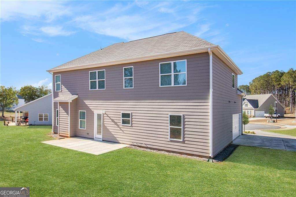 1101 Longleaf Trace Monroe, GA 30656 - Photo 34 of 36 a front view of a house with a garden and yard
