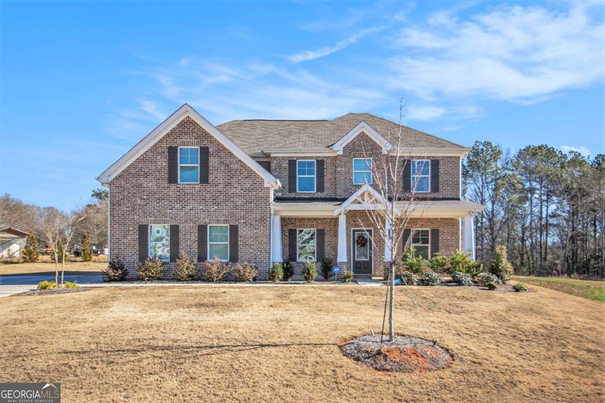 1101 Longleaf Trace Monroe, GA 30656 - Photo 4 of 36 a front view of a house with a yard