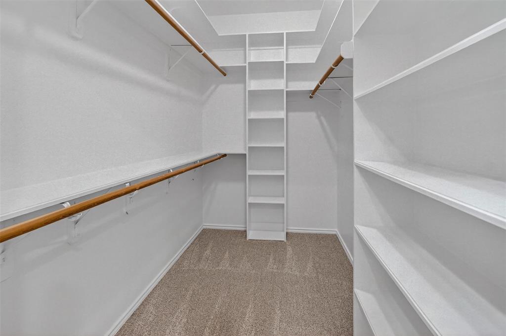2122 Clear Lake Road Weatherford, TX 76087 - Photo 27 of 40 One of two walk-in closets in the primary bedroom and bathroom with built-in shelves.