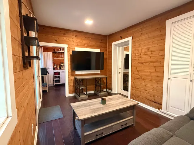 a living room with furniture flat screen tv and a fireplace
