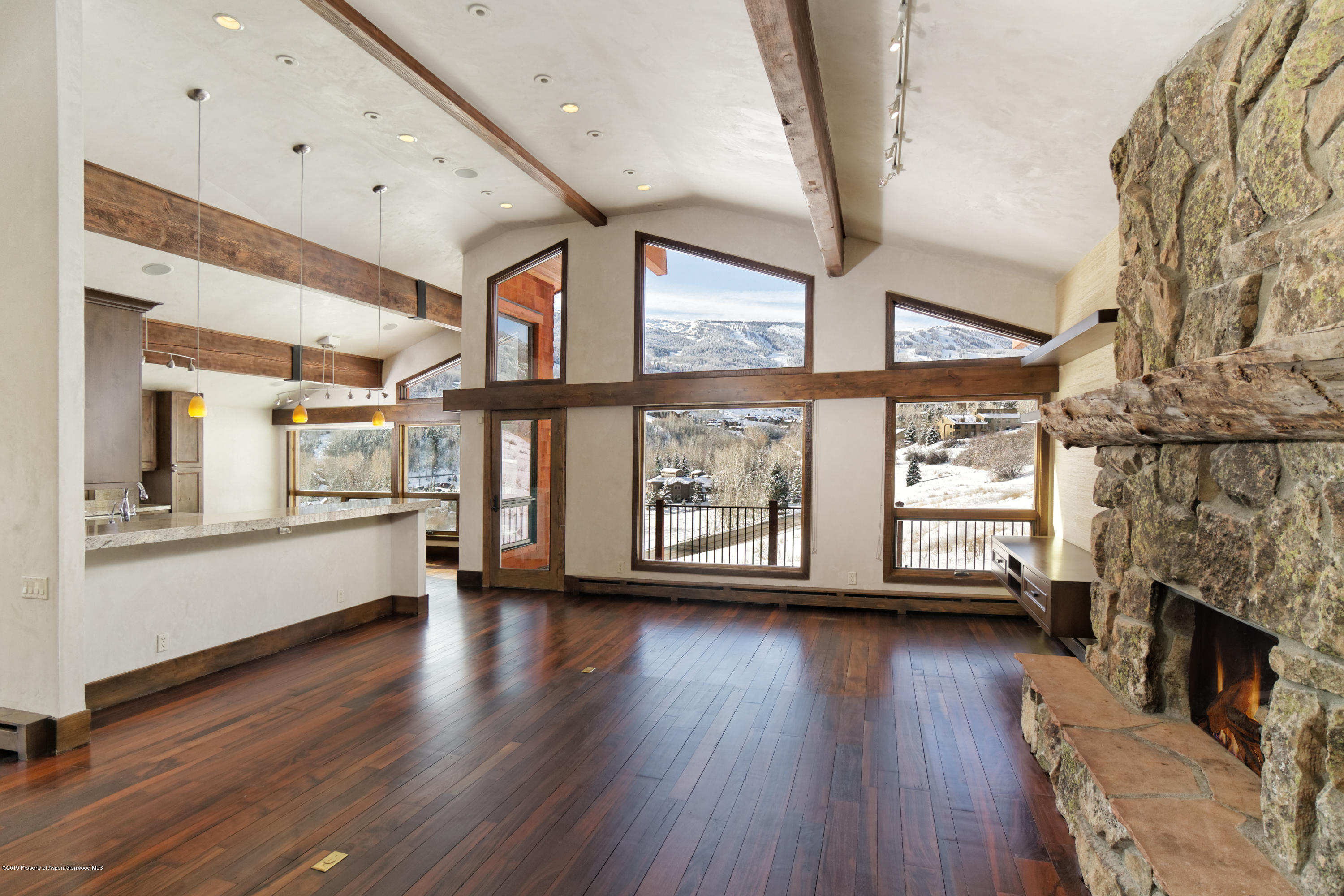 10 Martingale Lane Snowmass Village, CO 81615 - Photo 1 of 10 a view of an empty room with wooden floor and a window