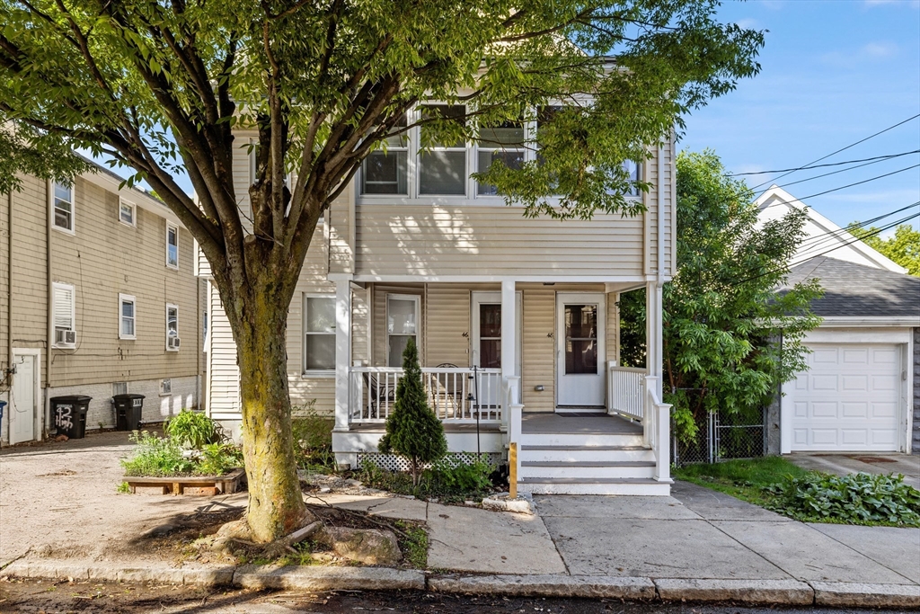 48 High Street, Unit 48 Somerville, MA 02144 - Photo 1 of 23 a front view of a house with a tree in front