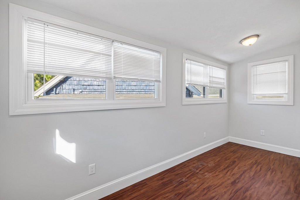 48 High Street, Unit 48 Somerville, MA 02144 - Photo 13 of 23 a view of an empty room with wooden floor and a window