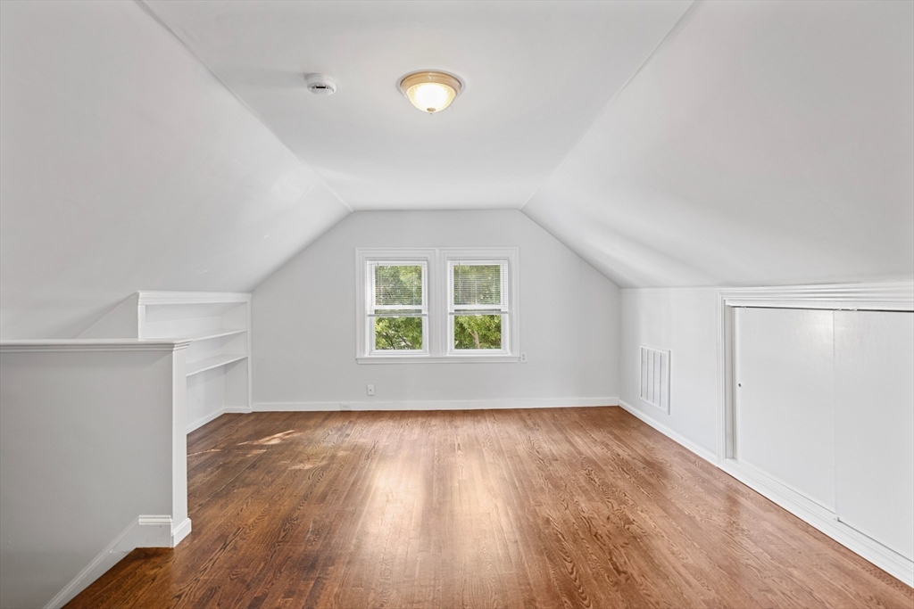 48 High Street, Unit 48 Somerville, MA 02144 - Photo 17 of 23 an empty room with wooden floor and windows