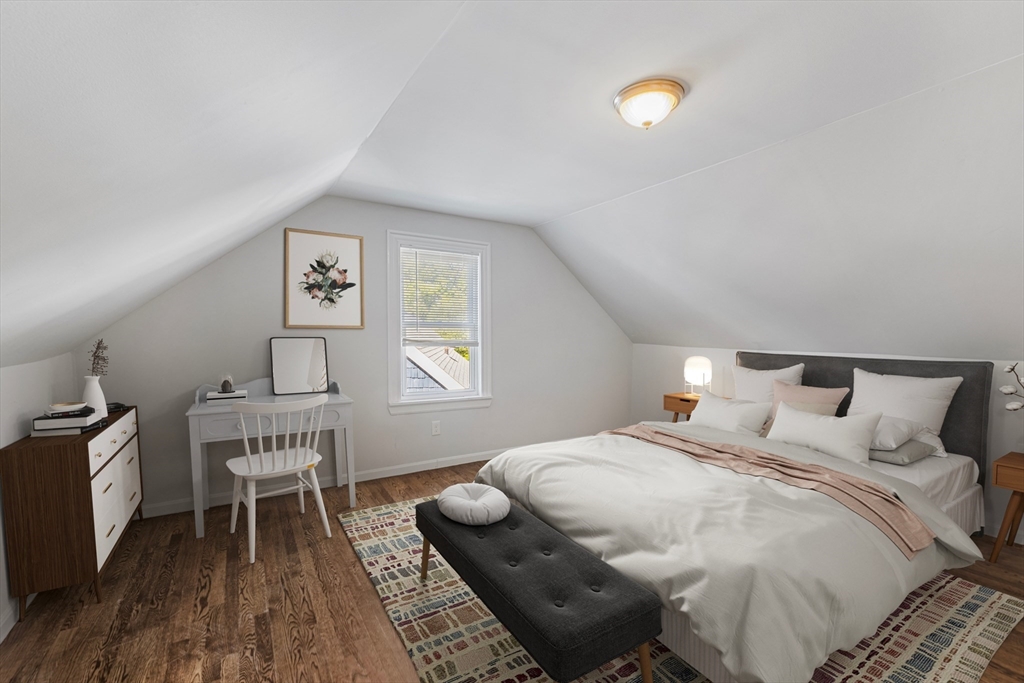 48 High Street, Unit 48 Somerville, MA 02144 - Photo 18 of 23 a bedroom with a bed and a chair
