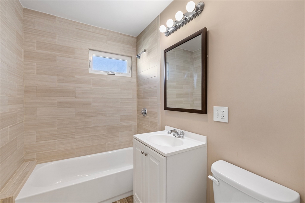 48 High Street, Unit 48 Somerville, MA 02144 - Photo 21 of 23 a bathroom with a sink a toilet and shower