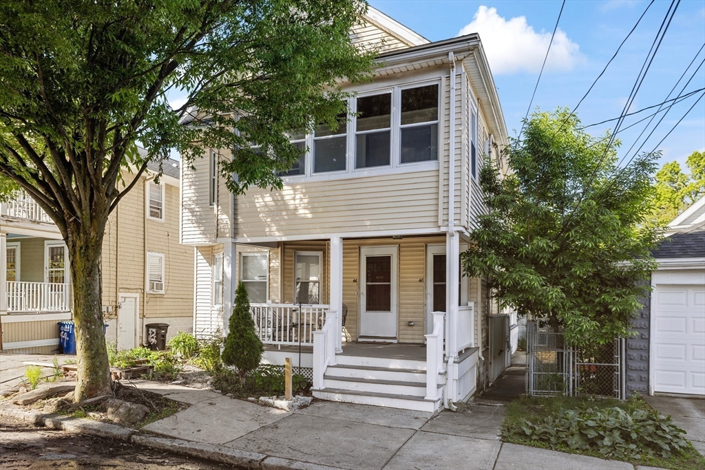 48 High Street, Unit 48 Somerville, MA 02144 - Photo 22 of 23 a front view of a house with a tree