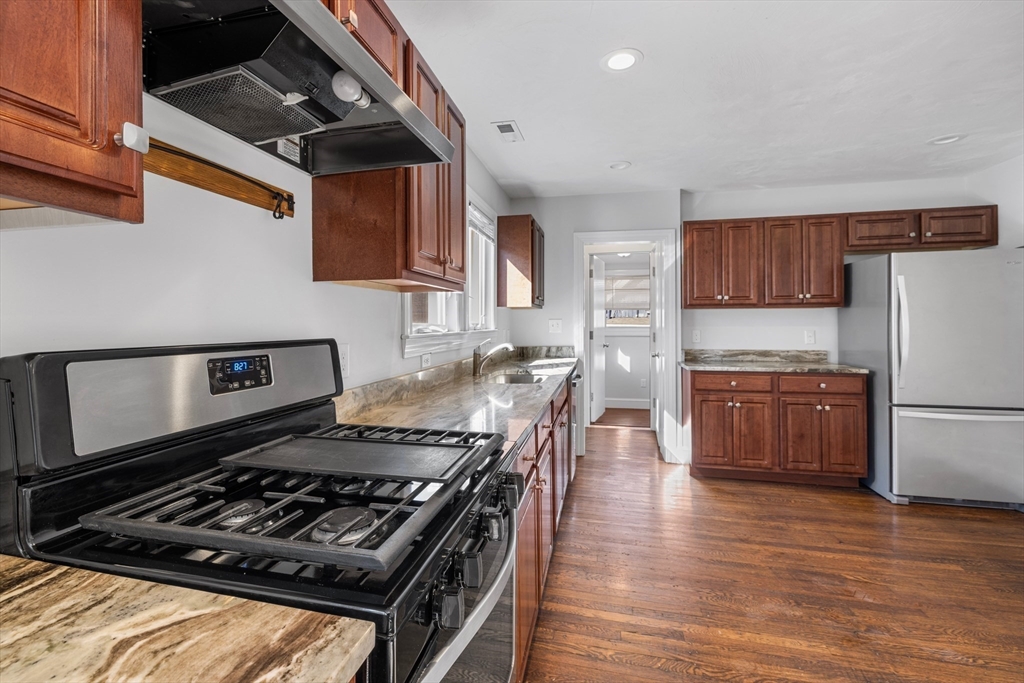 48 High Street, Unit 48 Somerville, MA 02144 - Photo 3 of 23 a kitchen with a stove and a refrigerator