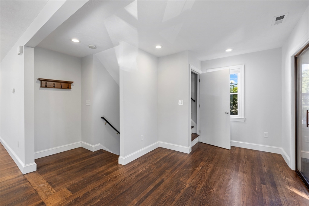 48 High Street, Unit 48 Somerville, MA 02144 - Photo 7 of 23 a view of empty room with wooden floor