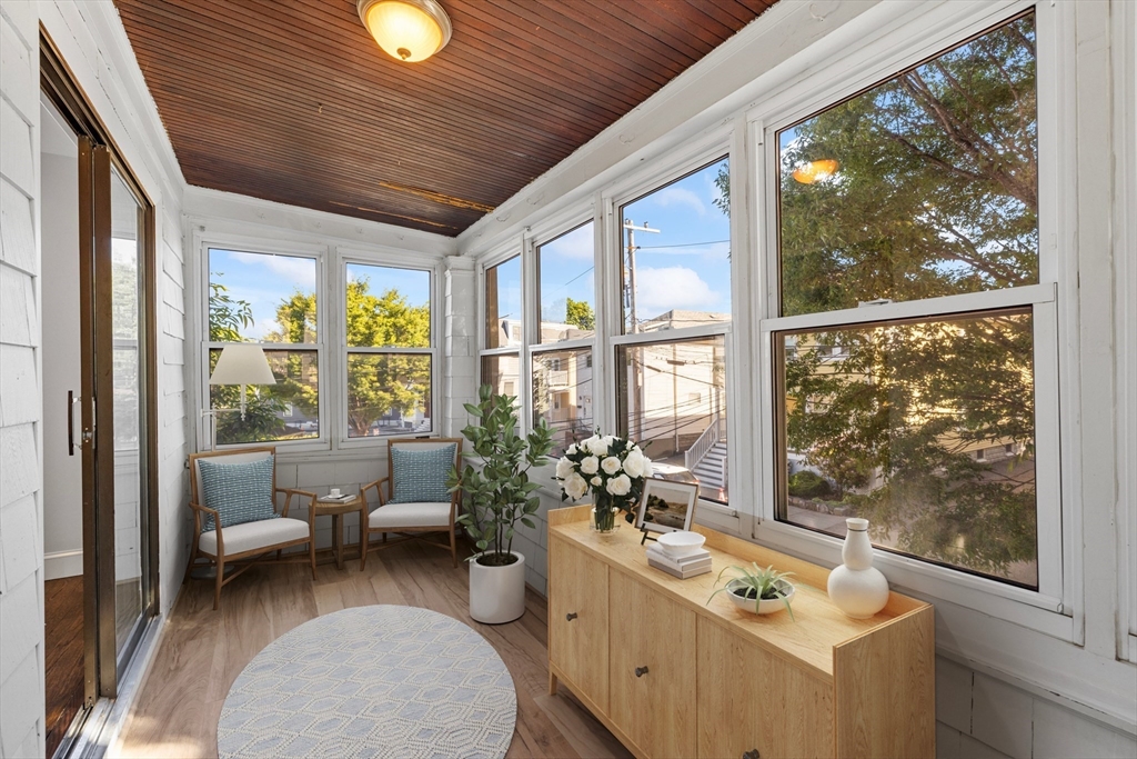 48 High Street, Unit 48 Somerville, MA 02144 - Photo 8 of 23 a room with furniture and large windows