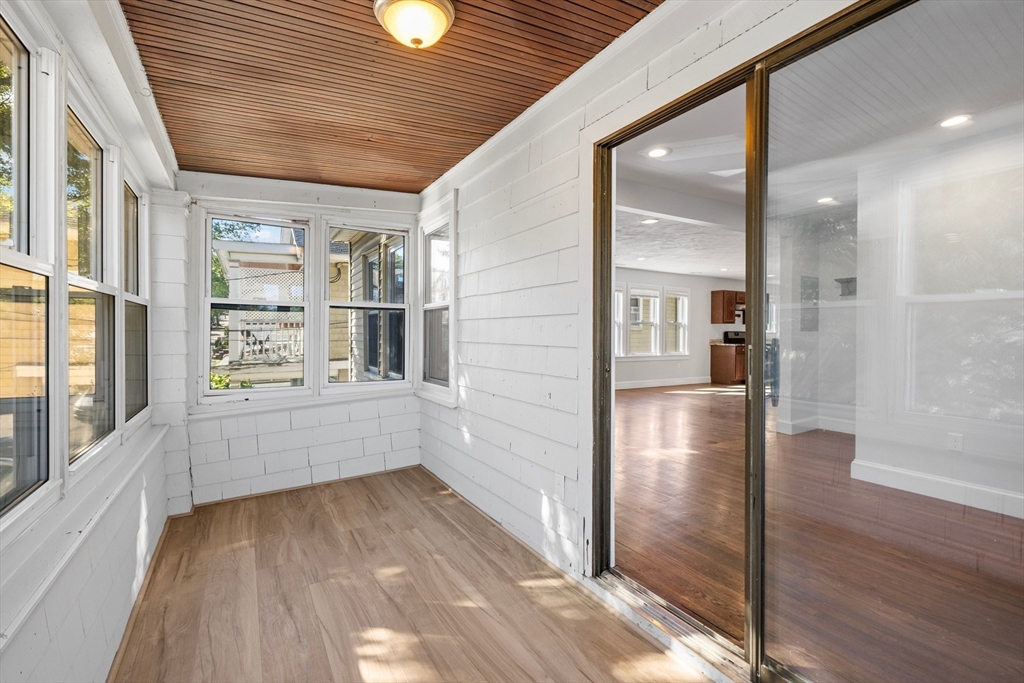 48 High Street, Unit 48 Somerville, MA 02144 - Photo 9 of 23 a view of a hallway with wooden floor and staircase