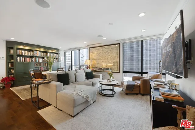 a living room with furniture and large flat screen tv