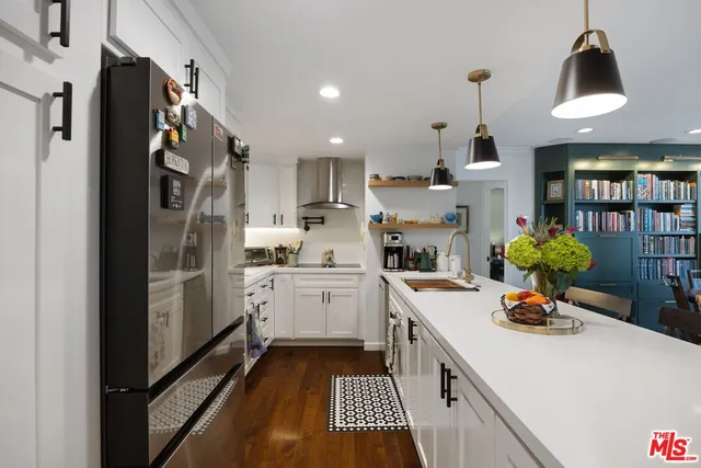 a kitchen with a sink appliances and cabinets