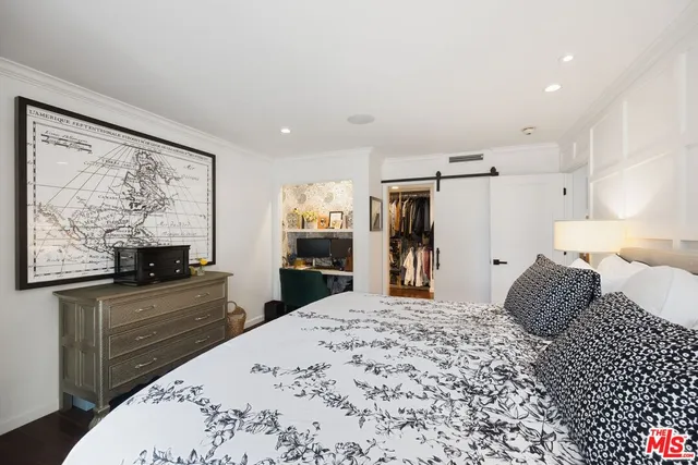 a bedroom with a bed and a flat screen television