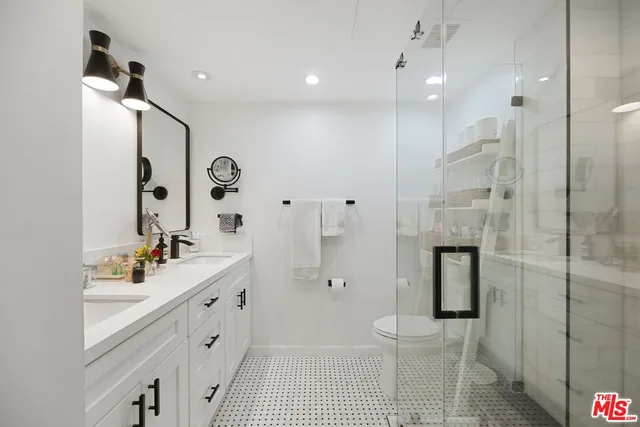 a bathroom with a double vanity sink mirror double and shower