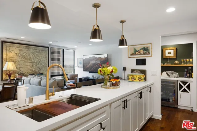 a kitchen with a sink dishwasher and a stove with wooden floor