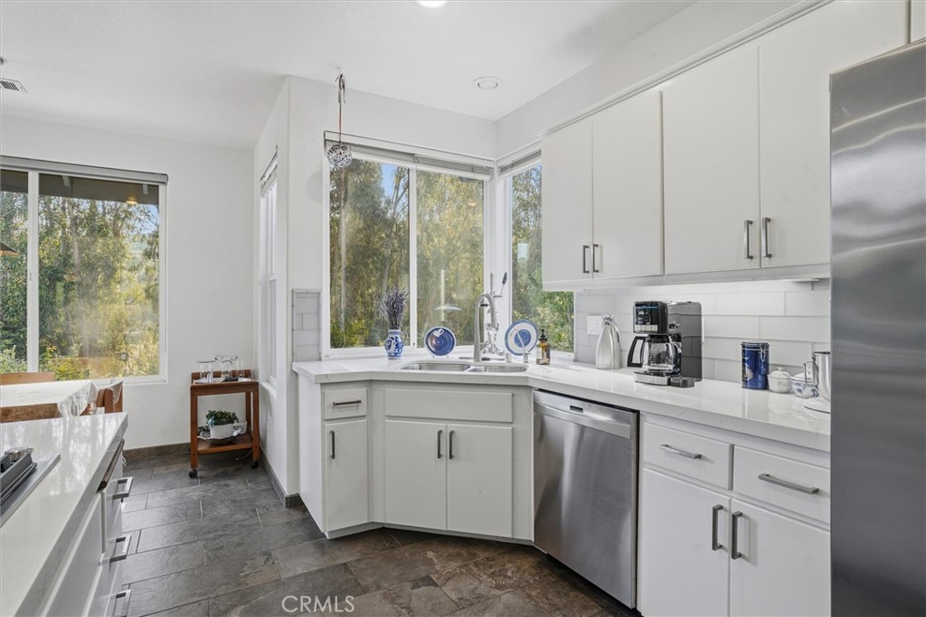 649 Asilo Arroyo Grande, CA 93420 - Photo 15 of 39 a kitchen with white cabinets and white appliances