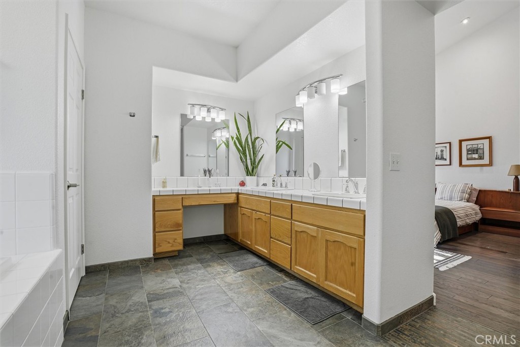 649 Asilo Arroyo Grande, CA 93420 - Photo 22 of 39 a bathroom with a double vanity sink a mirror and a bathtub