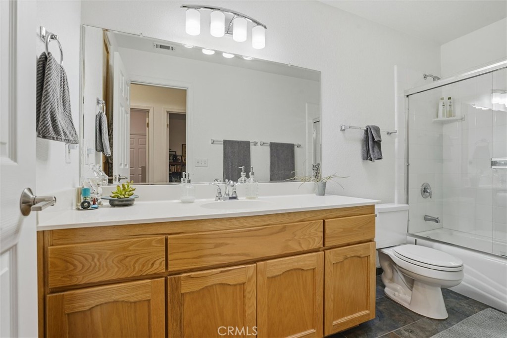 649 Asilo Arroyo Grande, CA 93420 - Photo 28 of 39 a bathroom with a granite countertop sink mirror vanity and toilet