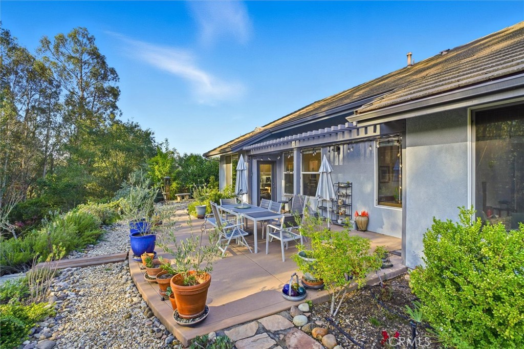 649 Asilo Arroyo Grande, CA 93420 - Photo 34 of 39 a view of a patio with table and chairs potted plants and floor to ceiling window