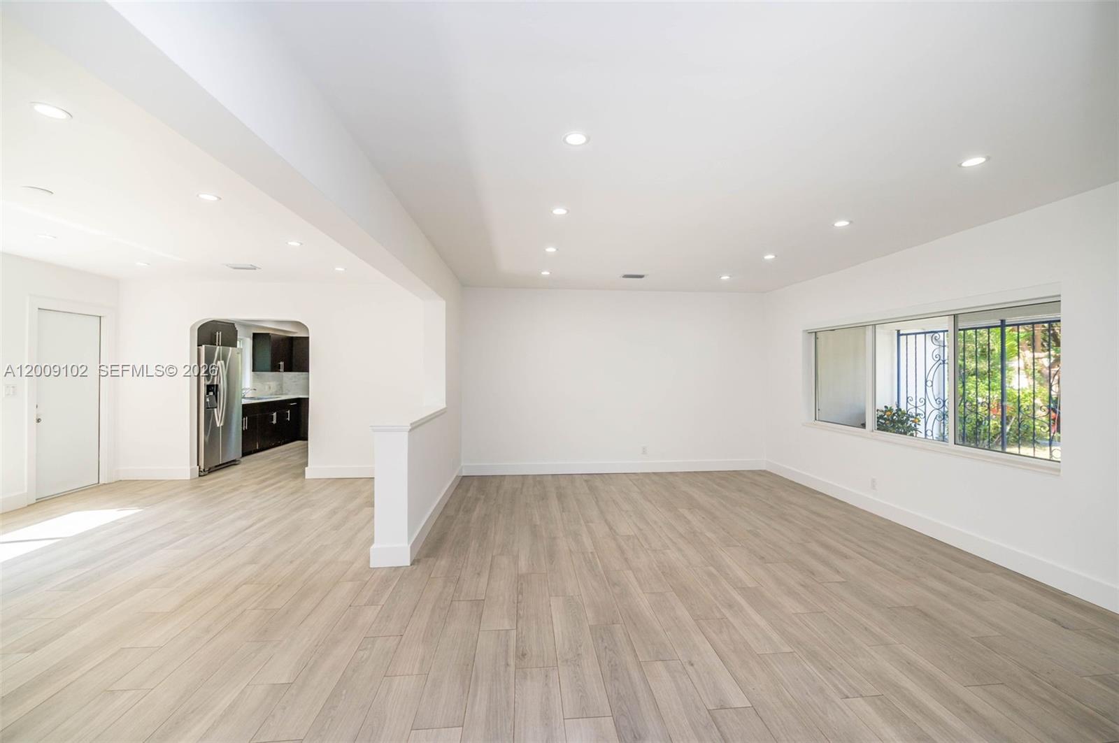 330 Southwest 27th Road Miami, FL 33129 - Photo 6 of 62 wooden floor in an empty room with a window