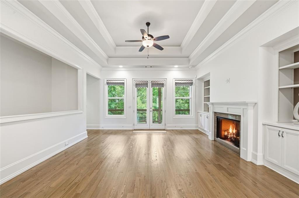 337 Rosshandler Road Suwanee, GA 30024 - Photo 17 of 45 a view of an empty room with wooden floor fireplace and a window