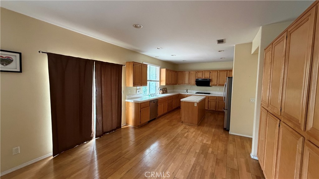 7134 Cumberland Place Rancho Cucamonga, CA 91739 - Photo 6 of 22 a kitchen with a refrigerator and a stove top oven