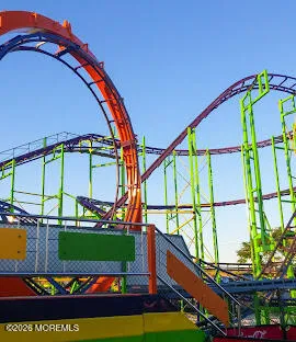 a view of swimming pool with a bench and trees in the background