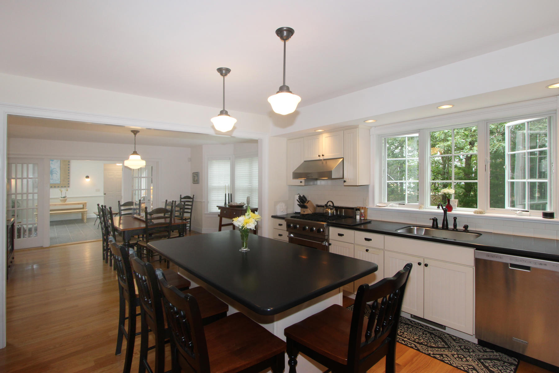 195 Cathedral Road Brewster, MA 02631 - Photo 16 of 54 a kitchen with a dining table chairs and wooden floor